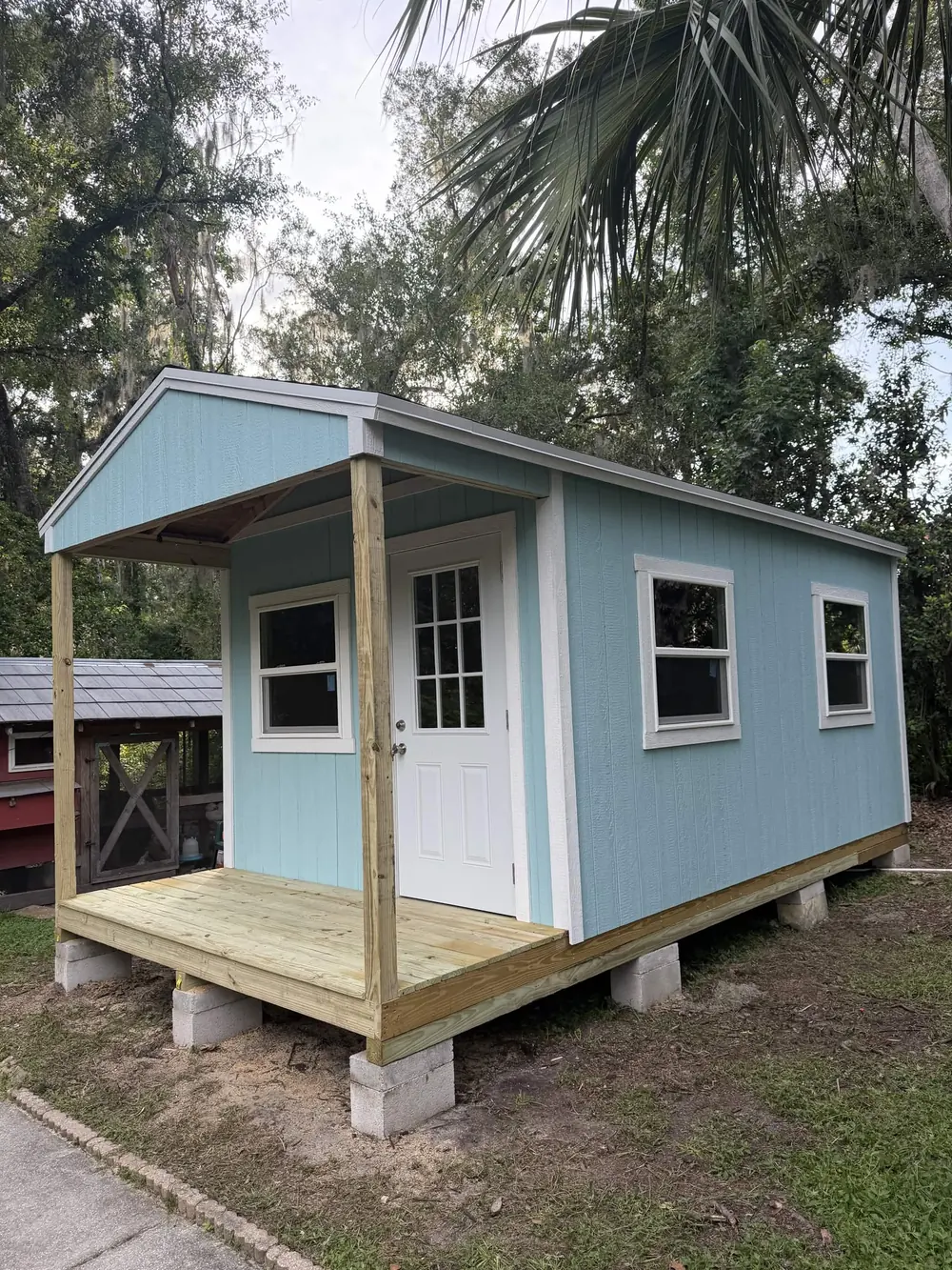 Blue custom porch shed built on-site by Patriot Outdoor Services