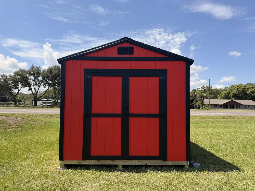 Red and black custom barn-style shed built by Patriot Outdoor Services